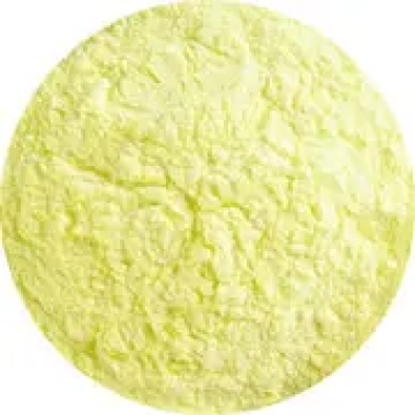 A close-up of a mound of yellow powder against a white background.